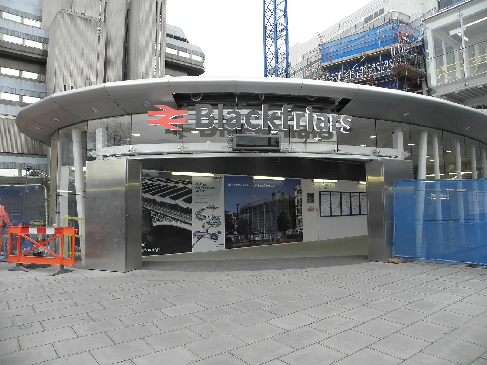 The curved glass South Bank entrance to Blackfriars station, with its red rail symbol