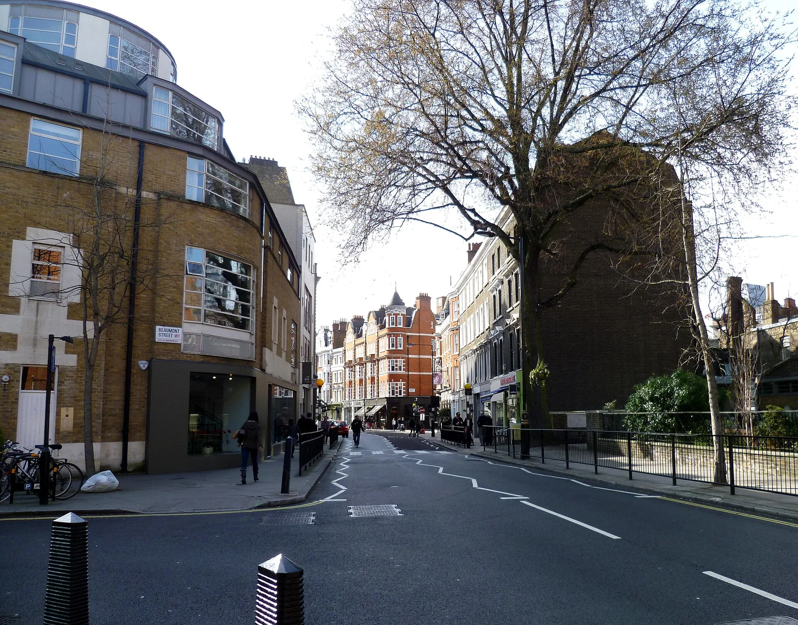 Marylebone High Street at its junction with Beaumont Street, with shops and a church