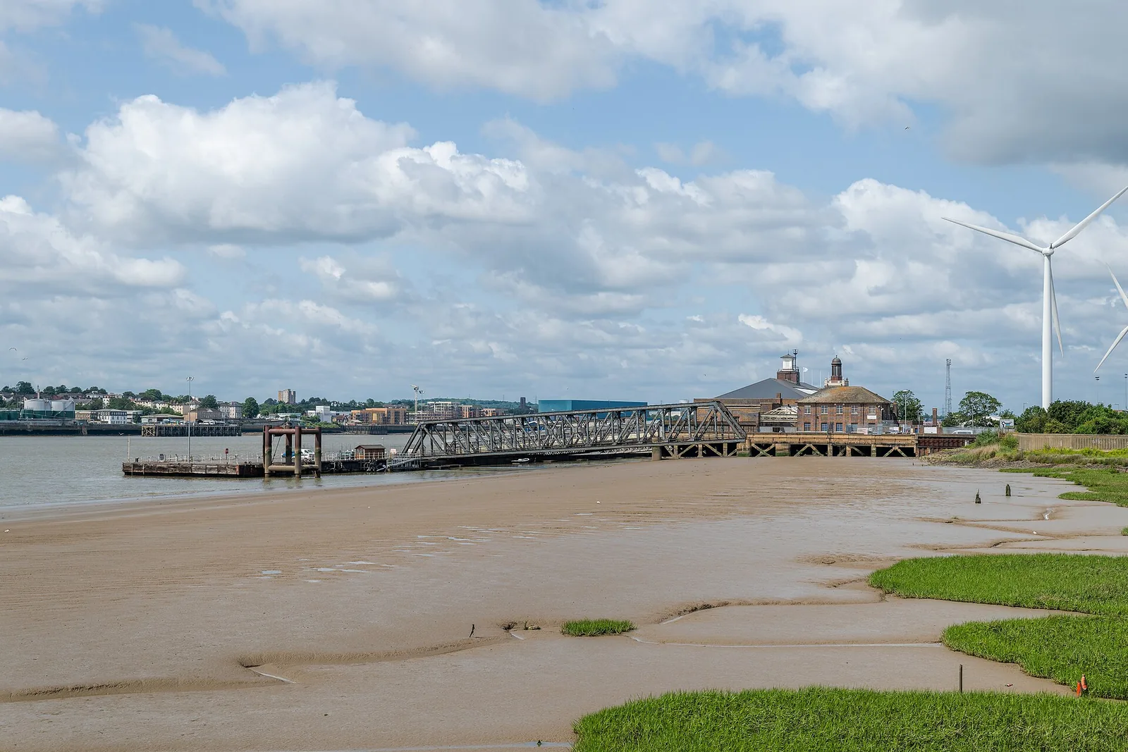 The historic Tilbury Riverside terminal and landing stage beside the Thames, viewed across exposed foreshore