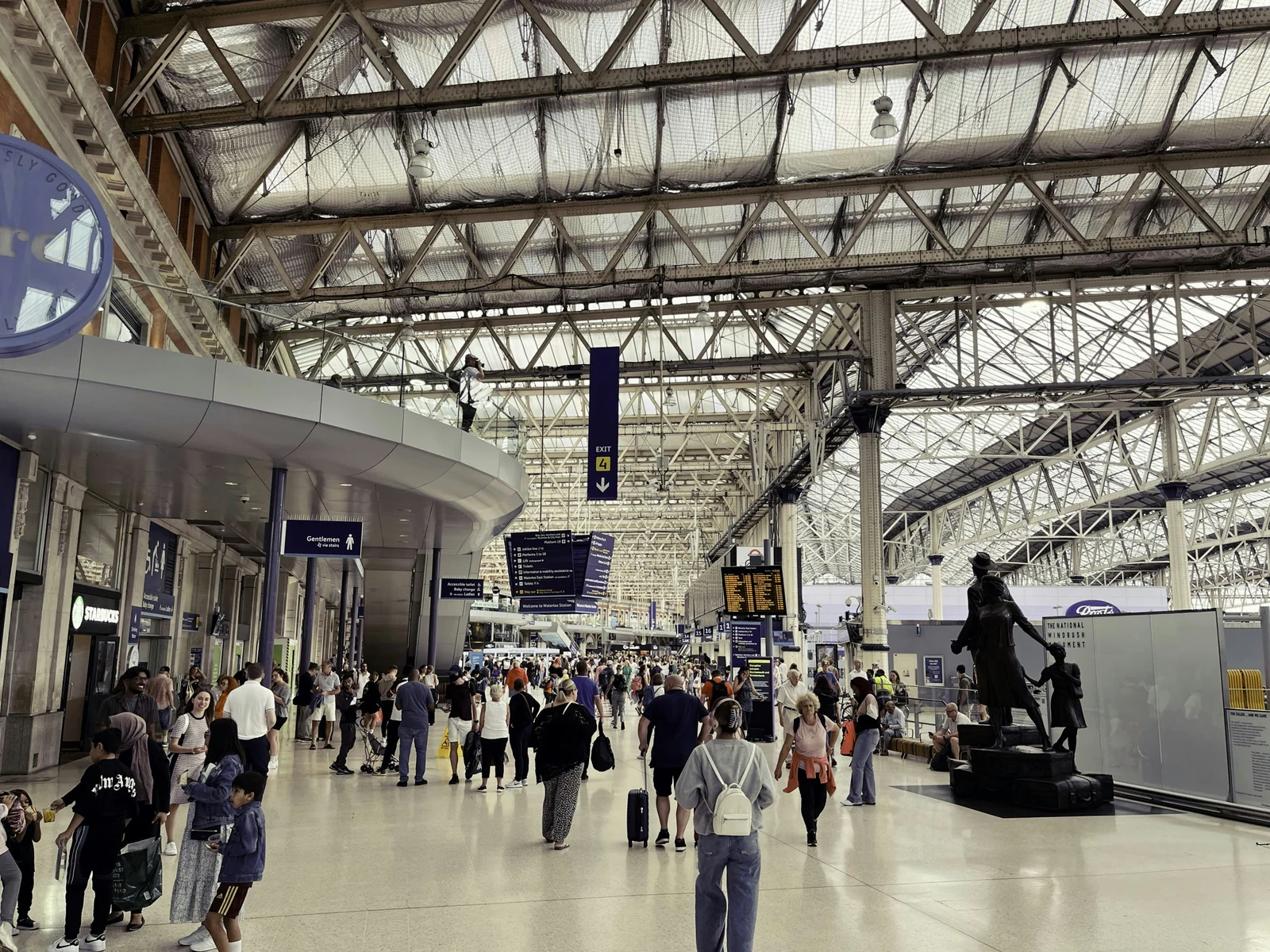 Passengers in the Waterloo station concourse beneath its roof.